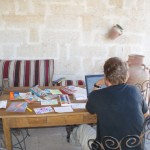Byron sits on the main terrace amid the kids' artistic endeavors.
